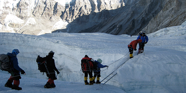 Climbers crossing a crevasse on Everest (Photo credit: Triump of the Spirit)